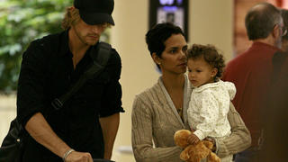 Actress Halle Berry shares an intimate moment with her boyfriend Gabriel Aubry as the couple push their 1-year-old daughter Nahla through the Los Angeles international airport to catch a flight. 