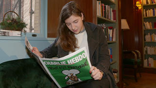 EXCLUSIVE: A French Women readsthe Magazine Charlie Hebdo at the French Bookstore Albertine Books in Manhattan, New York.