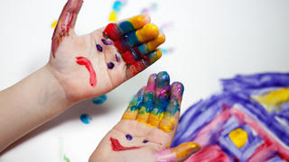 Little Children Hands doing Fingerpainting with various colors