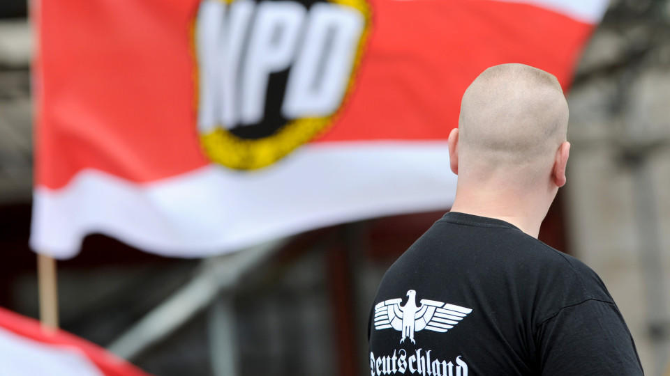 ARCHIV - Ein Unterstützer der NPD steht am 17.06.2012 mit einem Shirt mit der Aufschrift «Deutschland» bei einer NPD-Kundgebung am Strausberger Platz in Berlin. Foto: Matthias Balk/dpa (zu dpa «Verfassungsschutz-Ausschuss spricht über Gewalt von Neon