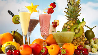 Milkshake or smoothie table with lots of summer fruits