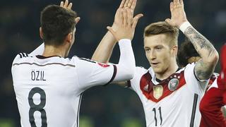 Germany's Marco Reus (R) celebrates with team mate Mesut Ozil after scoring against Georgia during their Euro 2016 qualifier soccer match in Tbilisi March 29, 2015. REUTERS/David Mdzinarishvili