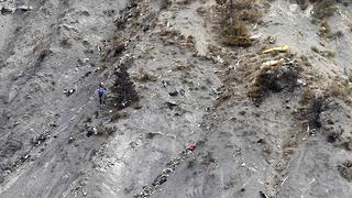 A rescue worker is seen near debris at the crash site of the Germanwings Airbus A320 near Seyne-les-Alpes, French Alps, March 30, 2015. The young German co-pilot, Andreas Lubitz, suspected of deliberately crashing a passenger plane in the French Alps, killing all 150 people on board including himself, told his girlfriend he was in psychiatric treatment, and that he was planning a spectacular gesture that everyone would remember, the German daily Bild reported on Saturday.  REUTERS/Claude Paris/Pool