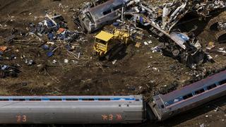 Emergency workers and Amtrak personnel inspect a derailed Amtrak train in Philadelphia, Pennsylvania May 13, 2015. The commuter rail route where an Amtrak train left the track on Tuesday was not governed by an advanced safety technology meant to prevent high-speed derailments, officials familiar with the investigation said on Wednesday. REUTERS/Lucas Jackson 