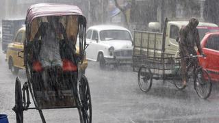 A man takes shelter inside his rickshaw during a heavy rain shower in Kolkata, India, June 25, 2015. REUTERS/Rupak De Chowdhuri