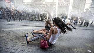 Riot police use a water cannon to disperse LGBT rights activist before a Gay Pride Parade in central Istanbul, Turkey, June 28, 2015. Turkish police fired water cannon and rubber pellets to disperse a crowd gathered in central Istanbul for the city's annual gay pride parade, a Reuters cameraman at the scene said. The police appeared intent on stopping the crowd gathering near Taksim Square, the cameraman said. Taksim is a traditional rallying ground for demonstrators and saw weeks of unrest in 2013. REUTERS/Kemal Aslan