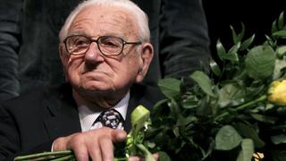 Nicholas Winton, aged 101, holds flowers while sitting on a stage after the premiere of the movie 'Nicky's family' which is based on his life story in Prague, in this file photograph dated January 20, 2011. A man who became known as the 'British Schindler' for saving hundreds of Czech children from Nazi persecution in the run-up to World War Two, has died at the age of 106. Winton died on July 1, 2015 with his daughter Barbara and two grandchildren at his side, according to a statement from the Rotary Club of Maidenhead in southern England, of which he was a former president.   REUTERS/Petr Josek/Files