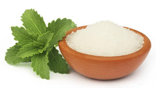 Stevia with sugar on a brown bowl