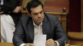 epa04848397 Greek Prime Minister Alexis Tsipras reads his notes during a parliamentary session in Athens, Greece, 15 July 2015. A debate on reforms that are key to a preliminary agreement with creditors to keep Greece out of bankruptcy takes place in the country's legislature, but fissures were already beginning to show among the ruling SYRIZA party. EPA/ORESTIS PANAGIOTOU +++(c) dpa - Bildfunk+++