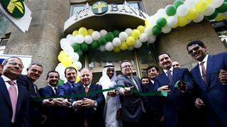 Officials cut a green ribbon to open KT Bank AG, Germany's first full-fledged Islamic bank, in Frankfurt, Germany, July 21, 2015. The bank, which is a wholly-owned subsidiary of Turkish lender Kuveyt Turk, aims to tap Europe's second-largest Muslim community of roughly 4 million Muslims, many of whose members are of Turkish descent.  REUTERS/Kai Pfaffenbach       TPX IMAGES OF THE DAY     