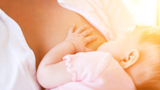 Mother nursing baby by breastfeeding