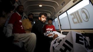 Abdul Majeed, brother of Shafqat Hussain who was convicted of killing a child in 2004, sits in an ambulance beside the body of Safqat after his execution in Karachi, Pakistan, August 4, 2015. REUTERS/Akhtar Soomro      TPX IMAGES OF THE DAY     