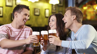 Young people with a beer in a restaurant
