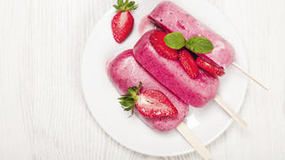 Strawberry popslice icecream on light wooden background