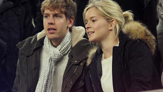 German Formula 1 and Grand Prix driver Sebastian Vettel (L) and his girlfriend Hanna Prater look at the playing field during the Spanish league football match between FC Barcelona and Valencia CF on February 19, 2012, at the Camp Nou stadium in Barcelona. AFP PHOTO / JOSEP LAGO (Photo credit should read JOSEP LAGO/AFP/Getty Images)