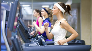 group of young people running on treadmill in gym