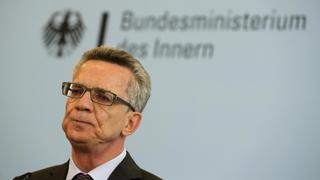 German Interior Minister Thomas de Maiziere pauses as he introduces Frank-Juergen Weise, new chief of the Office for Migration and Refugees federal labour office head (not pictured) during a news conference in Berlin, Germany September 21, 2015. The words read 'Interior Ministry'.  REUTERS/Fabrizio Bensch