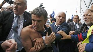 A shirtless Xavier Broseta (2ndL), Executive Vice President for Human Resources and Labour Relations at Air France, is evacuated by security after employees interrupted a meeting with representatives staff at the Air France headquarters building at the Charles de Gaulle International Airport in Roissy, near Paris, France, October 5, 2015. Air France confirmed in a meeting with staff on Monday that it plans to cut 2,900 jobs by 2017 and shed 14 aircraft from its long-haul fleet as part of efforts to lower costs, two union sources said.     REUTERS/Jacky Naegelen  TPX IMAGES OF THE DAY