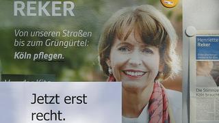 A paper reads "More than ever." at an election campaign poster of Henriette Reker at the place where the candidate for mayor was stabbed in Cologne, Germany October 18, 2015. Reker, an independent candidate running for mayor of the German city of Cologne, was stabbed in the neck and severely wounded on Saturday October 17 while she was campaigning in the city, police said. Reker and an aide were both severely injured by the attacker, a 44-year-old man, police said. Three other people who came to their aid were also injured, though not severely.   REUTERS/Wolfgang Rattay