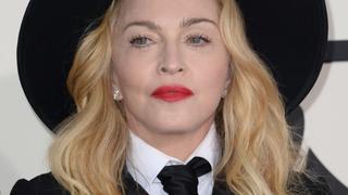 Madonna arrives on the red carpet for the 56th Grammy Awards at the Staples Center in Los Angeles on January 26, 2014.   AFP PHOTO/ROBYN BECK        (Photo credit should read ROBYN BECK/AFP/Getty Images)