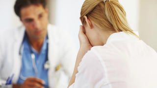 Portrait of female doctor sharing her problems with doctor in office