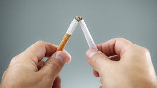 Breaking a cigarette in half concept for quitting smoking and healthy lifestyle
