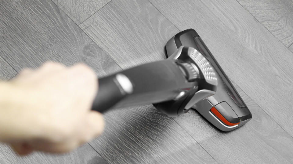 cleaning floor with cordless vacuum cleaner