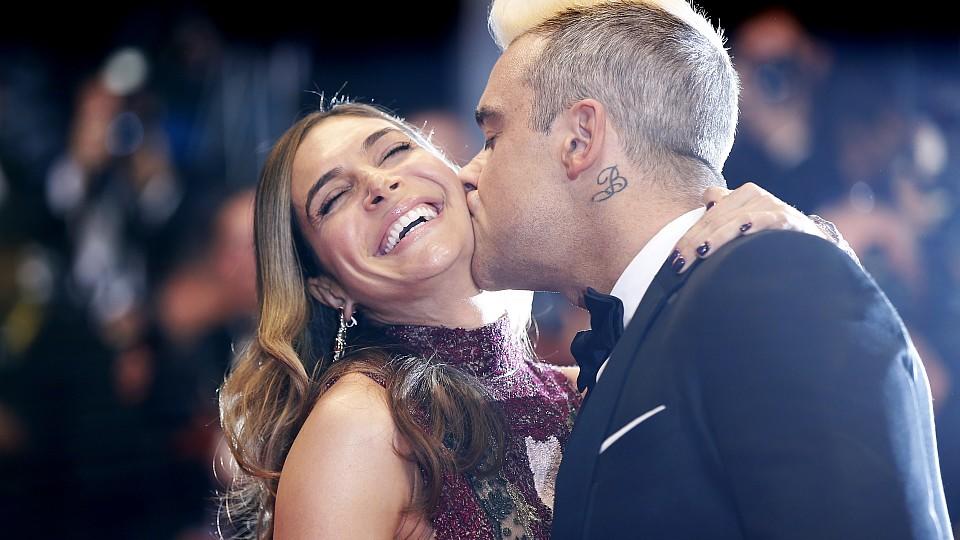 British singer Robbie Williams (R) kisses his wife Ayda Field as they arrive for the screening of the film 'The Sea of Trees' at the 68th Cannes Film Festival in Cannes, southeastern France, on May 16, 2015.   AFP PHOTO / VALERY HACHE        (Photo c