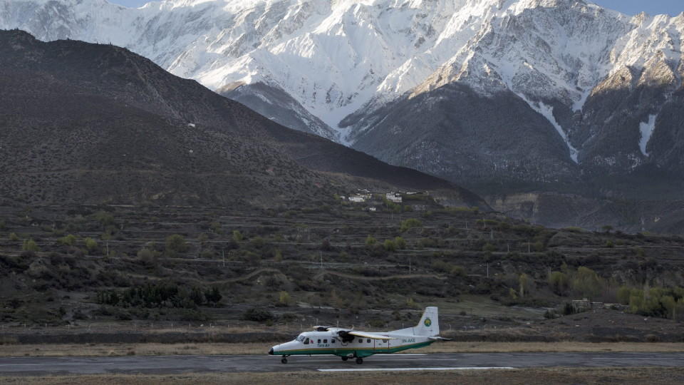 epa05177765 A picture made available on 24 February 2016 shows a twin aircraft of the Tara Airlines landing at Jomsom Airport, in Jomsom, a popular resort town west of Kathmandu, Nepal, 04 April 2015, as Mount Nilgiri is visible on the background. Ac