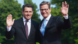 CORRECTING THE PHOTOGRAPHERS NAME-German Foreign Minister Guido Westerwelle (R) and his partner Michael Mronz pose upon arrival for a state dinner for the US president in Berlin, on June 19, 2013. US President Barack Obama walks in John F. Kennedy's footsteps on his first visit to Berlin as US president, but encounters a more powerful and sceptical Germany in talks on trade and secret surveillance practices.   AFP PHOTO / OLIVER LANG        (Photo credit should read OLIVER LANG/AFP/Getty Images)