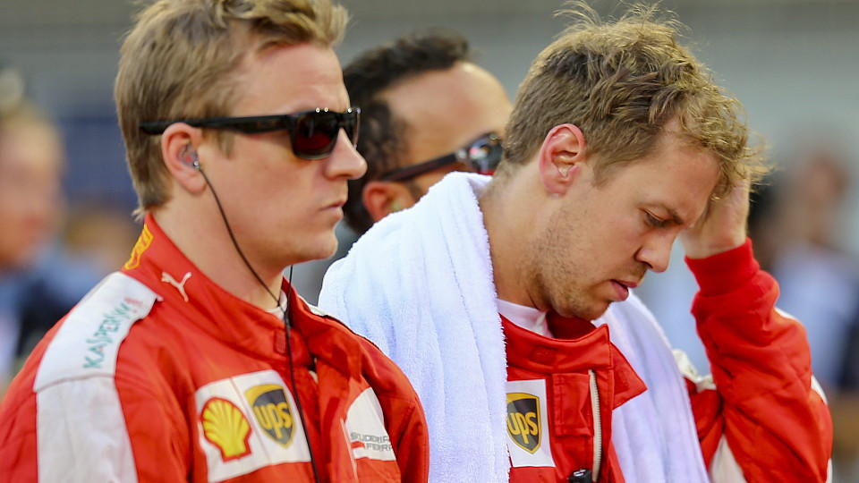epa04712583 German Formula One driver Sebastian Vettel (R) of Scuderia Ferrari and Finnish Formula One driver Kimi Raikkonen (L) of Scuderia Ferrari at the grid prior the 2015 Bahrain Formula One Grand Prix, at the Sakhir circuit near Manama, Bahrain