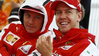 Ferrari Formula One driver Sebastian Vettel (R) of Germany and team mate Kimi Raikkonen of Finland attend the unveiling ceremony of a monument in Suzuka, Japan, September 24, 2015, ahead of Sunday's Japanese F1 Grand Prix. REUTERS/Thomas Peter
