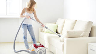 Attractive girl with vacuum cleaner