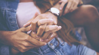Cropped image of young couple holding hands with a vintage developing style