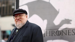 FILE - In this March 18, 2013, file photo, author George R.R. Martin arrives at the premiere for the third season of the HBO television series "Game of Thrones" at the TCL Chinese Theatre in Los Angeles. In a Jan 2, 2016, blog entry, Martin acknowledges he missed the Dec. 31 deadline for the latest book in the "Game of Thrones" fantasy series, titled ¿The Winds of Winter,¿ and the finished novel is still months away. ¿Game of Thrones,¿ the HBO television season based on the novel will start airing in April 2016, while he¿s still writing.  (Photo by Matt Sayles /Invision/AP, File) |