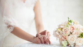 The bride's hands near the bouquet