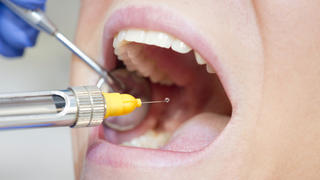 "Dental anesthetic. Close-up, focus on syringe"