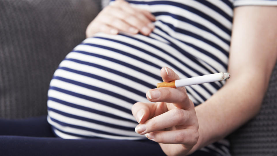 Close Up Of Pregnant Woman Smoking Cigarette