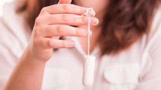 Vaginal Tapopon in woman's hand - studio shot