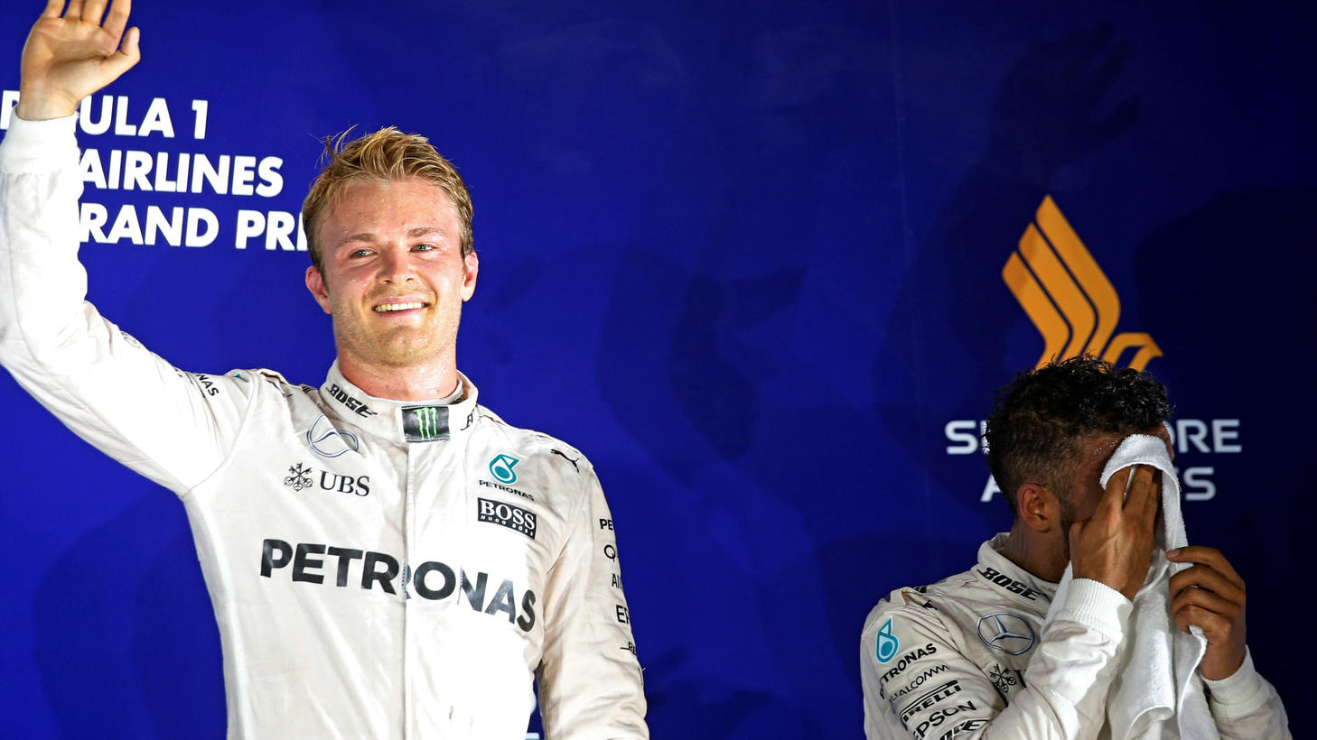 Formula One - F1 - Singapore Grand Prix - Marina Bay, Singapore- 18/9/16  Mercedes' Nico Rosberg of Germany celebrates winning the race next to Mercedes' Lewis Hamilton of Britain. REUTERS/Edgar Su 