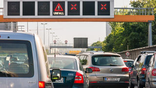 Vienna, Austria - May 28, 2016: Cars stuck in traffic jam and warning signs after accident on motorway in Vienna, Austria