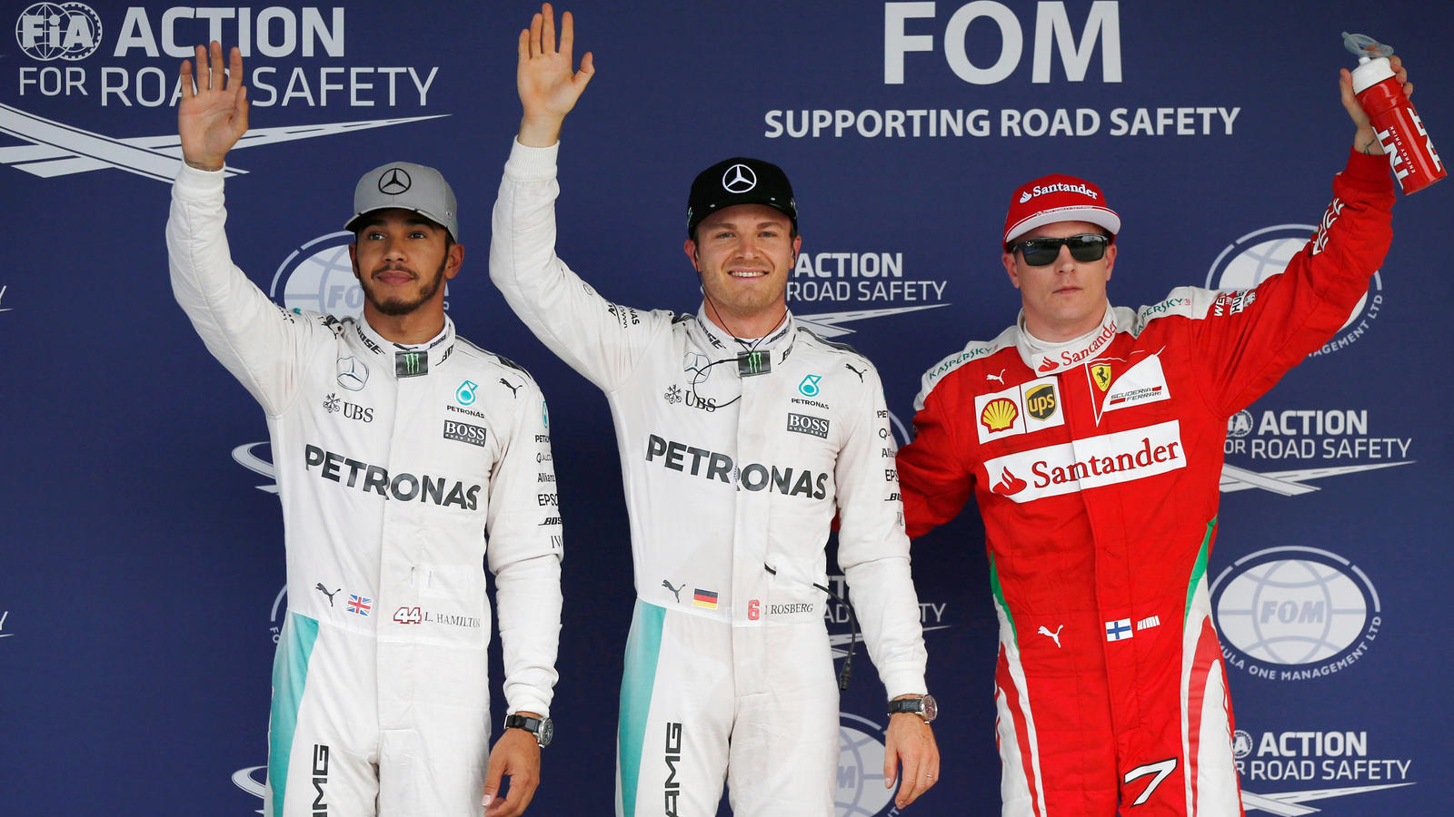 Formula One F1 - Japanese Grand Prix - Suzuka Circuit, Japan - 8/10/16. Mercedes' Lewis Hamilton of Britain, Mercedes' Nico Rosberg of Germany and Ferrari's Kimi Raikkonen of Finland (L-R) wave their hands after the qualifying session. REUTERS/Toru H