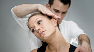 Chiropractic adjustment - Chriopractor working on patient's neck