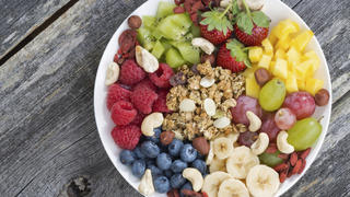 ingredients for a healthy breakfast in one dish on wooden background, top view
