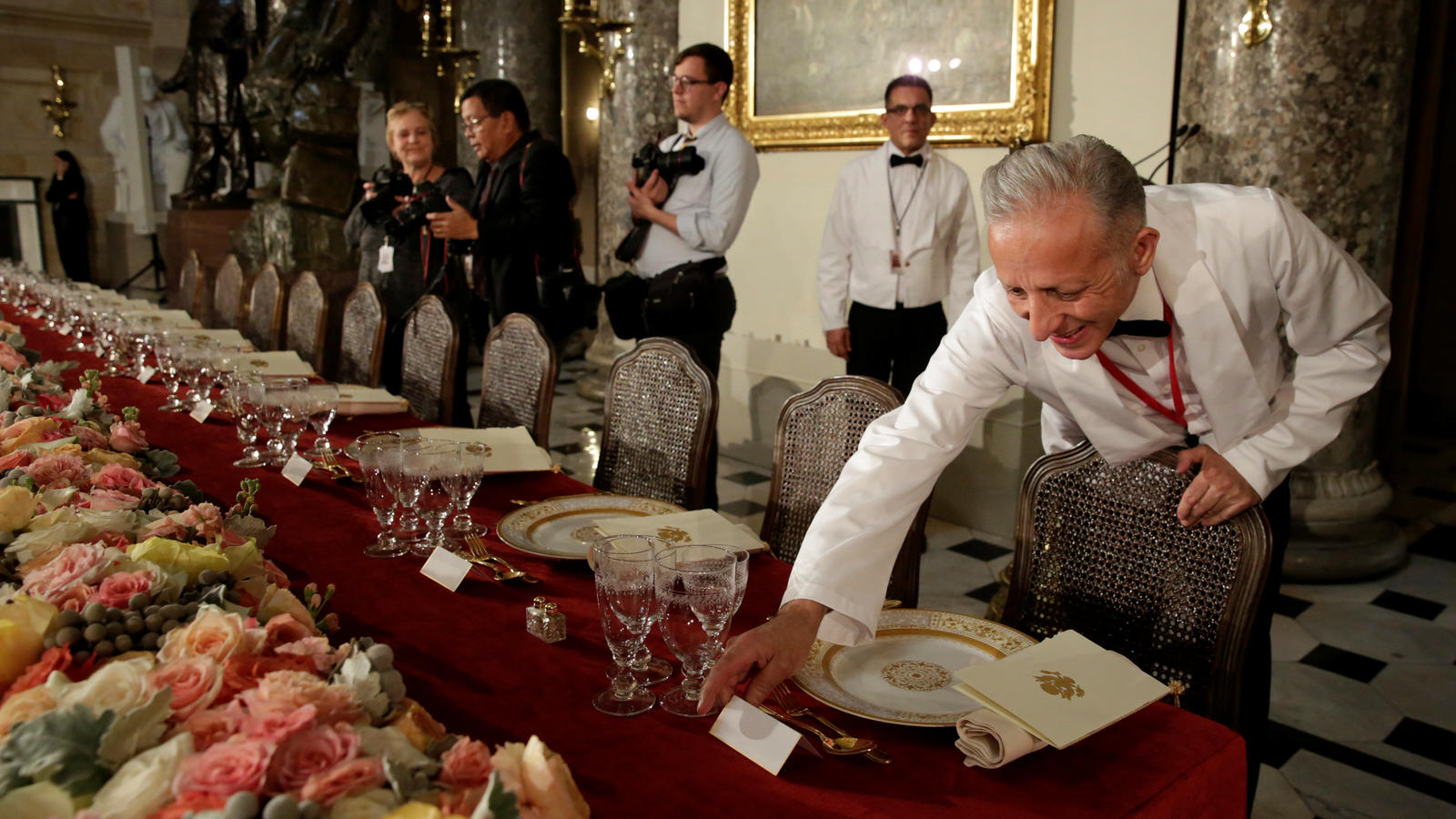 A head waiter puts name tags for U.S. President Donald Trump and members of Congress before the Inaugural Luncheon in Statuary Hall on Capitol Hill in Washington, U.S., January 20, 2017. REUTERS/Yuri Gripas