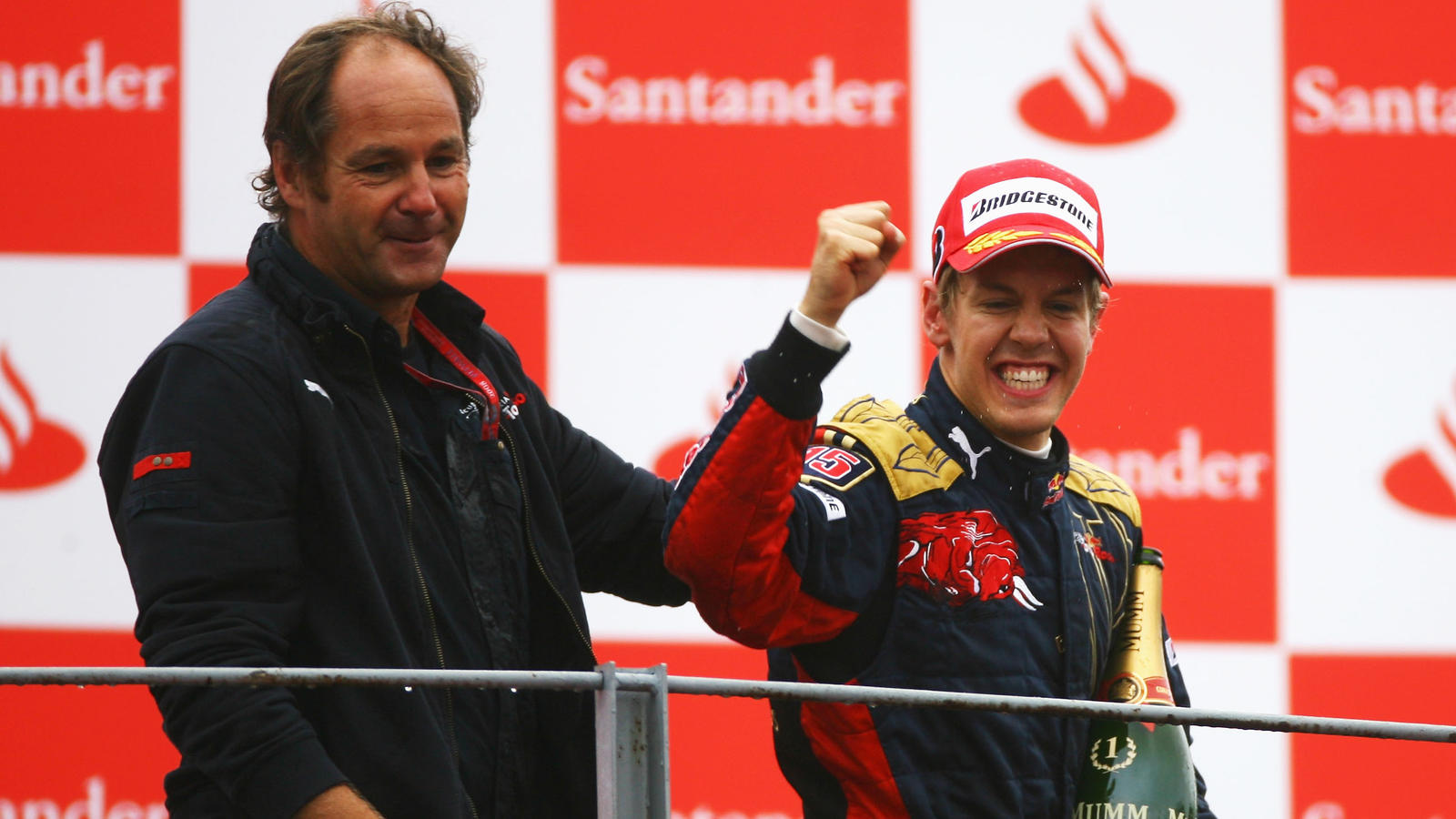 MONZA, ITALY - SEPTEMBER 14:  Sebastian Vettel (R) of Germany and Scuderia Toro Rosso celebrates on the podium with Scuderia Toro Rosso Team Owner Gerhard Berger after winning the Italian Formula One Grand Prix at the Autodromo Nazionale di Monza on 