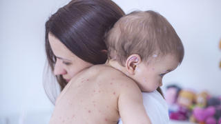Mother nursing sick child At Home