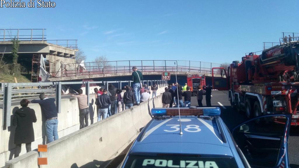 HANDOUT - Polizei und Schaulustige stehen am 09.03.2017 vor der eingestürzten Brücke auf der Autobahn A14 zwischen Ancona Sud und Loreto in Italien. Zwei Menschen, die darunter begraben wurden, starben. Neben den beiden Toten gebe es auch zwei Verlet