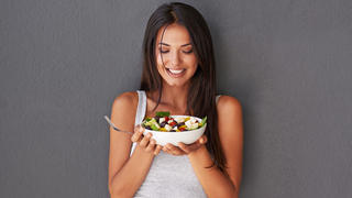 Shot of an attractive young woman looking happy while holding a salad bowlhttp://195.154.178.81/DATA/i_collage/pi/shoots/783751.jpg