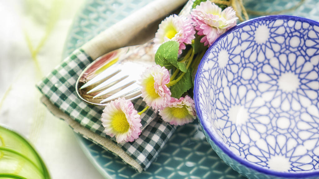 Colorful decorated Easter Place Setting with Easter Eggs, flowers on the table